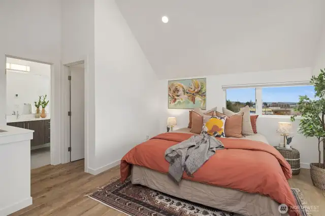 Ensuite loft primary with deep closet and balcony access.