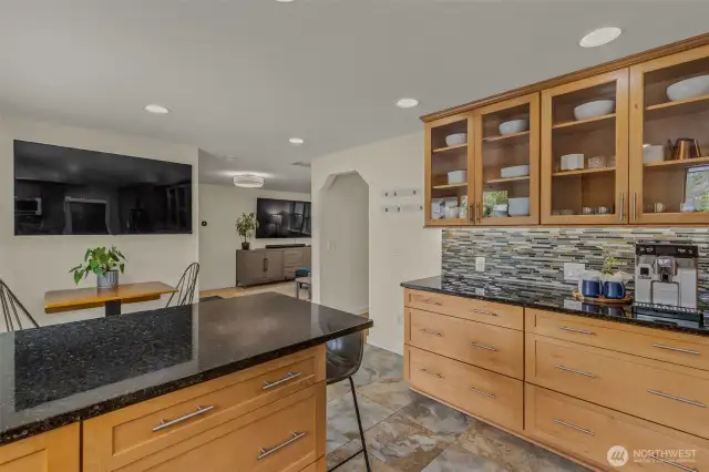 Eat-in kitchen with space for counter height stools and small table with sliding door access to backyard.