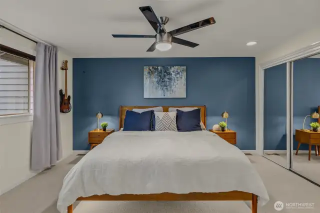 Spacious primary bedroom with double mirror closets, ceiling fan, and ensuite 5-piece bathroom.