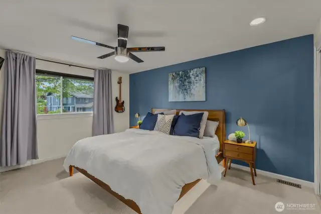 Spacious primary bedroom with double mirror closets, ceiling fan, and ensuite 5-piece bathroom.