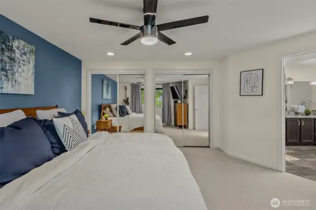 Spacious primary bedroom with double mirror closets, ceiling fan, and ensuite 5-piece bathroom.