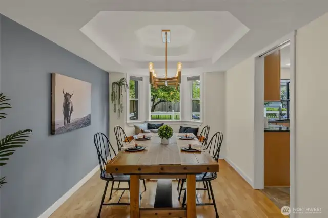 Dining area with backyard facing bay window and built-in seat. access to kitchen.
