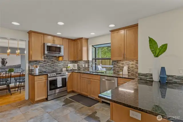 Spacious eat-in kitchen and appliances 2-3 years old including refrigerator, stove/oven, and ultra quiet dishwasher.