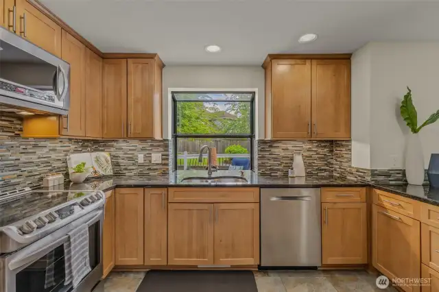 Spacious eat-in kitchen and appliances 2 3 years old including refrigerator, stove/oven, and ultra quiet dishwasher.