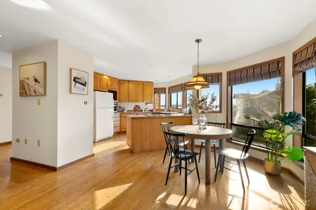 Open kitchen w/ Sound views, casual dining area & den