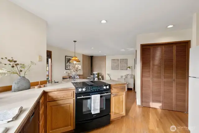 Open kitchen w/ Sound views, casual dining area & den