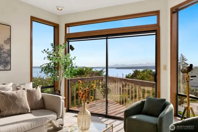 Formal dining & living facing Western Sound & Mountain Views, opening to deck