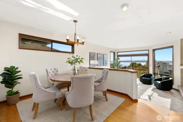 Formal dining & living facing Western Sound & Mountain Views, opening to deck