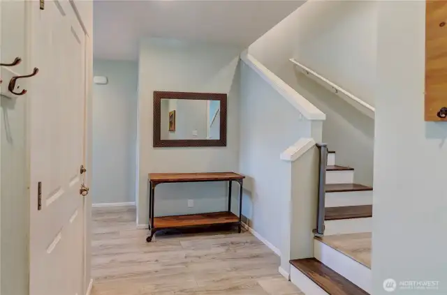 Welcome home! This inviting entryway sets the tone with stylish flooring, modern finishes, and a warm, functional layout that leads you upstairs to the heart of the home.
