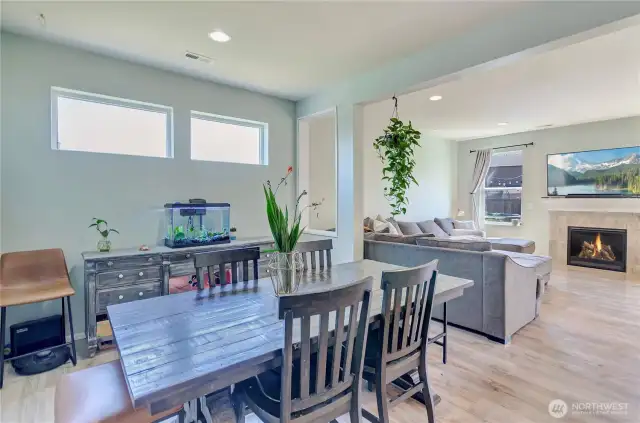 Bright and inviting open-concept living! The dining area flows seamlessly into the cozy living room with a modern fireplace—perfect for everyday living and entertaining.
