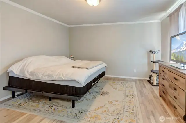 Peaceful and private, this spacious primary suite features beautiful flooring, soft natural light, and ample space to create your perfect retreat.