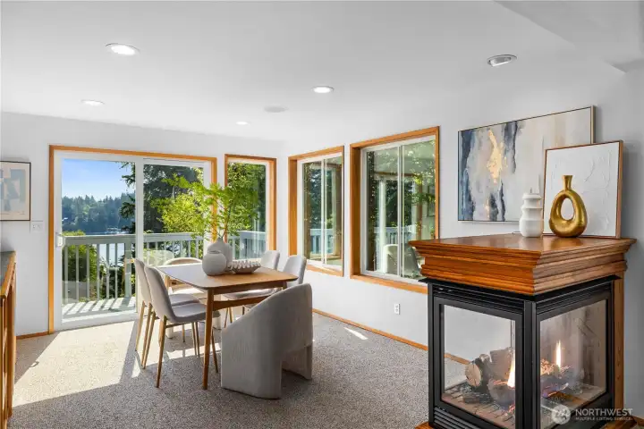 A custom multi-sided gas fireplace was installed by current owners. Sliding doors lead to the main level deck with stunnin views of Agate Pass.