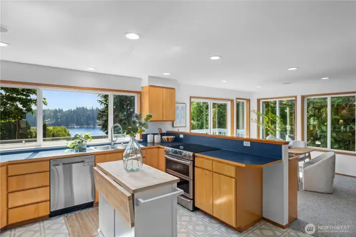 Another perspective showing the natural light and water view. The additional tax lot can be seen through the dining room window.