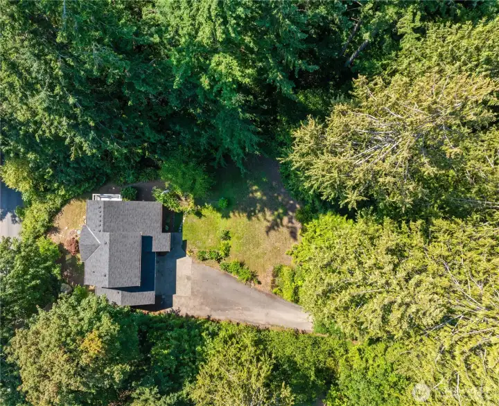 An aerial view of the property - a perfect combination of mature trees and open spaces which bathe the home in natural light all day.