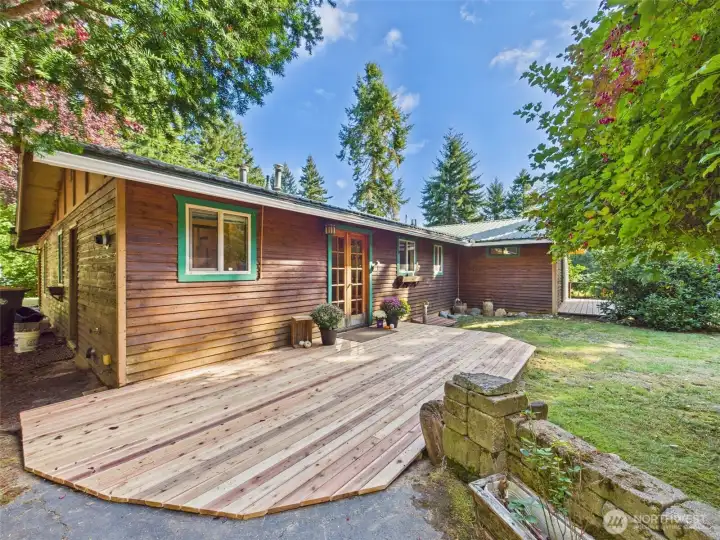 New Cedar deck leads to French door entry.