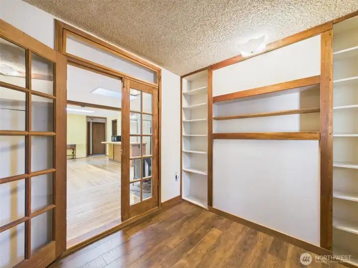 French doors lead to charming library or office space.