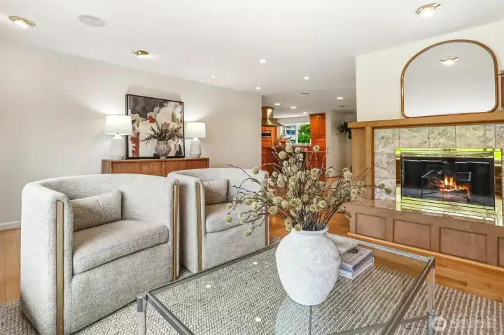 Gas fireplace in living room looking towards kitchen