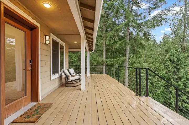 New lifetime deck surface with custom-made railings, providing a durable and inviting outdoor space to relax and take in the scenic surroundings.