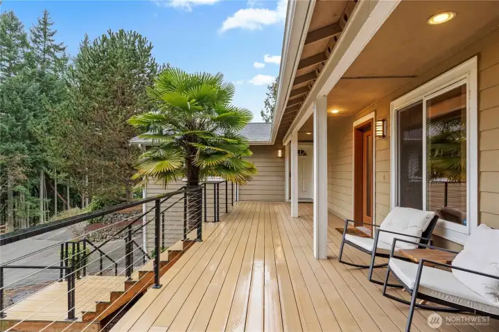 New lifetime deck surface with custom-made railings, providing a durable and inviting outdoor space to relax and take in the scenic surroundings.