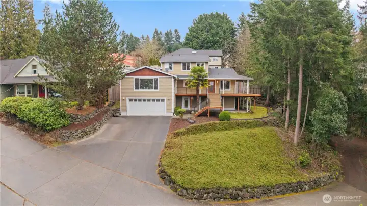 Gracefully elevated and framed by mature trees, this beautiful home offers a peaceful setting and standout curb appeal.