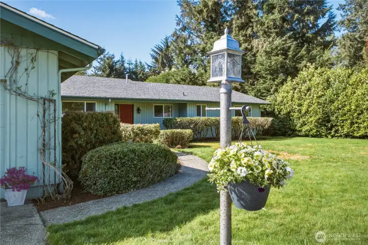 Lovely mature landscaping surrounds the home, providing privacy and views of greenery year round.