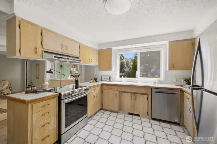 This delightful kitchen features stainless steel appliances and ample cupboard space.