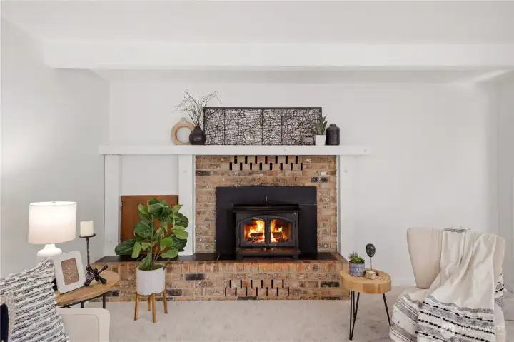 To the left of the fireplace is a pass-through cubby. Load wood from the attached garage into this cupboard and then access it from this side!