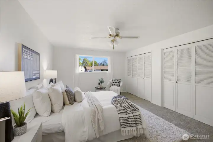 A wall of closets in the primary bedroom provides ample space for wardrobe and shoes!