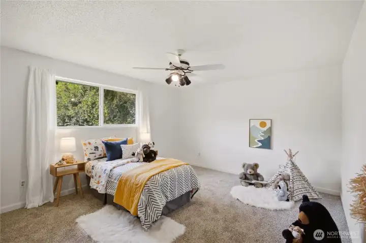 This darling second bedroom looks out over the backyard of the home. The fresh paint offers a neutral palate for your home decor and personal designs!