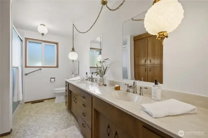 Serving the bedrooms is this extra-sized main bath, featuring a Bathfitter step-in shower installed in 2019.