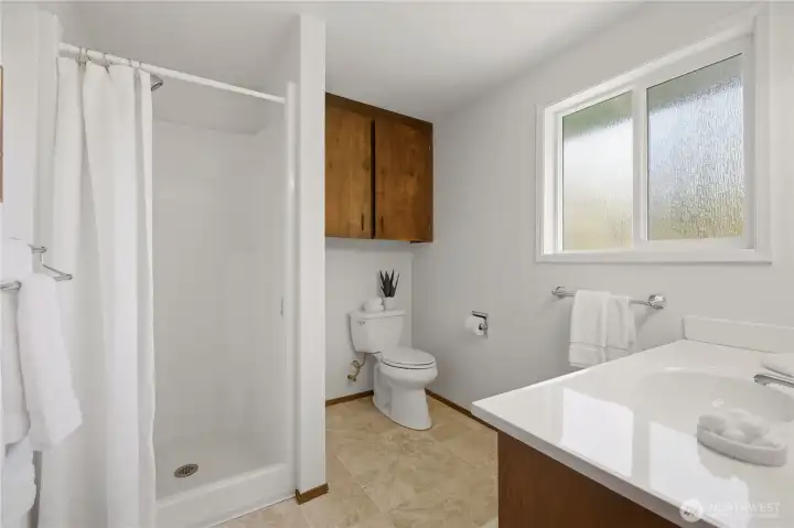 Just off the laundry room and attached garage is this 3/4 bath.