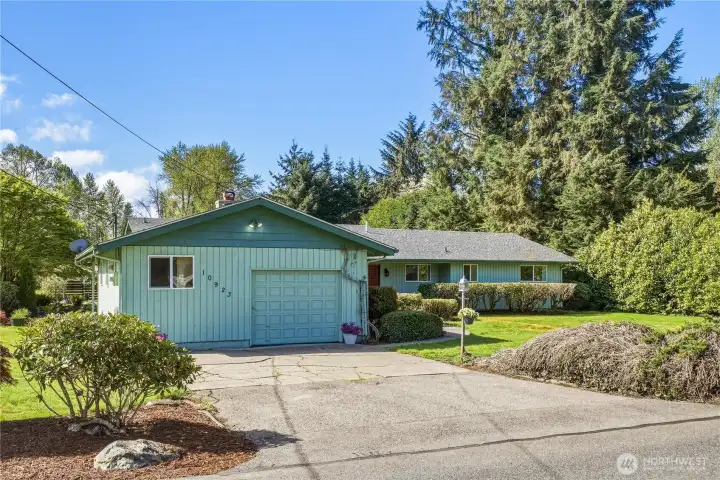 There are two driveways on this property, with paved parking for 10+ cars. Shown here is the driveway to the attached garage.