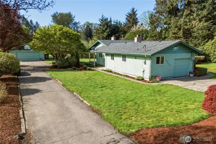 Along the east side of the property is this long paved driveway to the oversized, detached garage. Fabulous parking for guests, or for RV or boat storage.