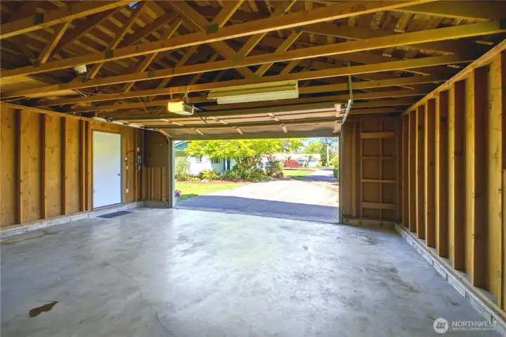 The interior of the detached garage is a clean slate, ready for shelves or a tool system.