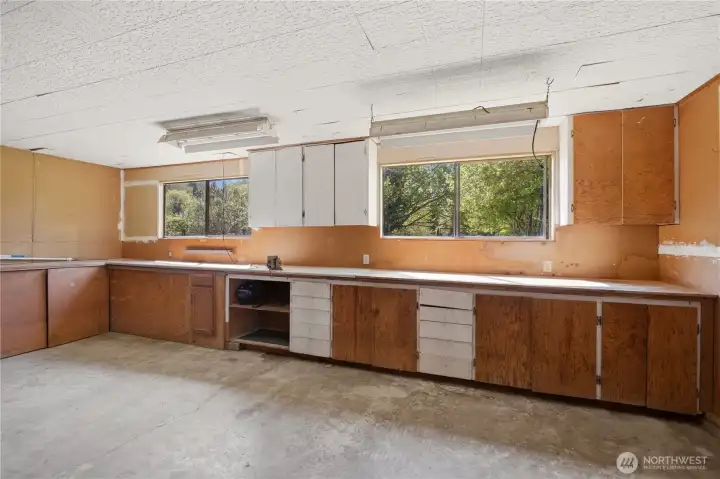 In the back room of the detached garage you'll find this separate workshop space, complete with cupboards and counters for projects and hobbies.
