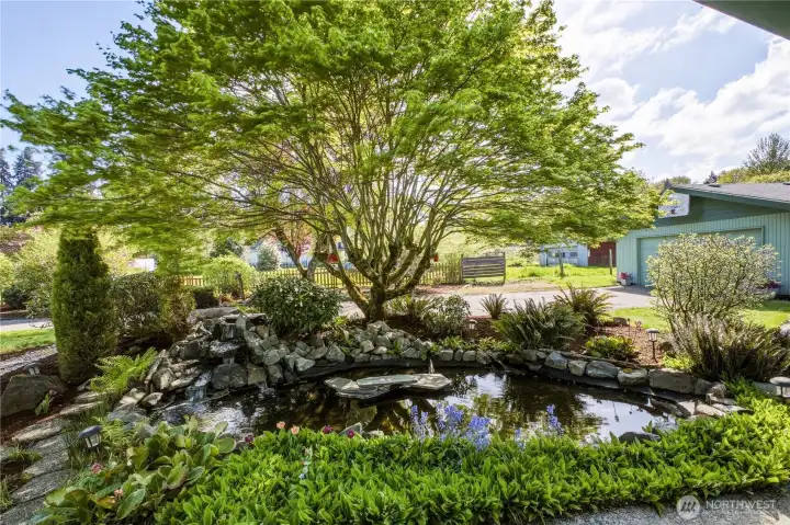 Enjoy a picturesque setting on this lovely property! The koi pond with a water feature provides a soothing sound and a perfect spot to unwind.