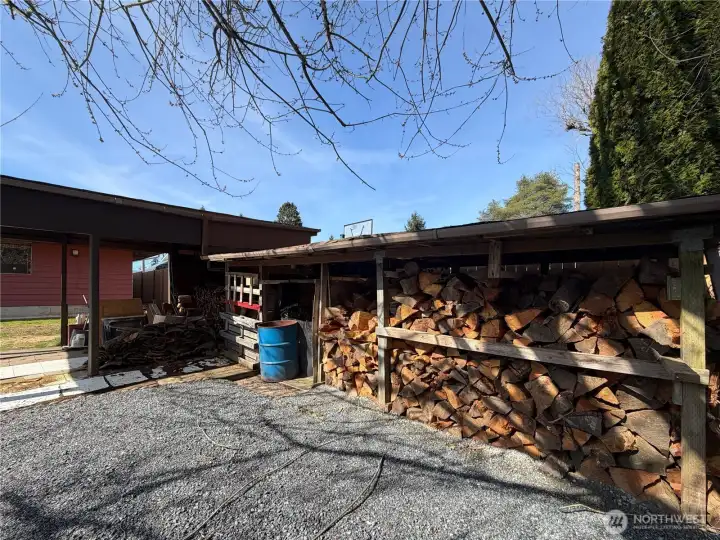 Wood shed and covered carport.