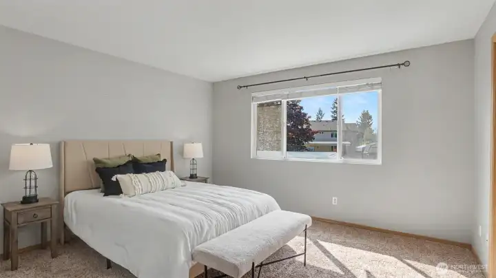 Large primary bedroom with west facing window and view of your backyard