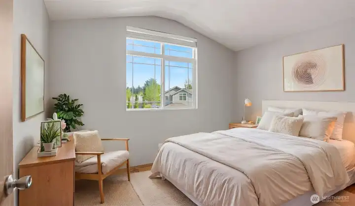 Open-concept living and dining area with abundant natural light and cozy gas fireplace