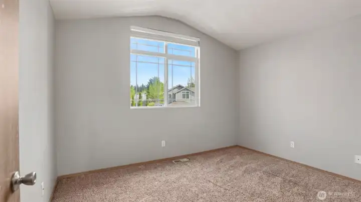 Versatile, light-filled space with vaulted ceilings—perfect for a cozy bedroom, creative craft room, or your own unique vision