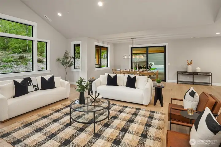 Vaulted ceilings and black-framed windows create a bright, modern aesthetic.