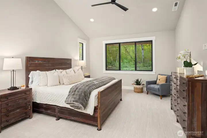 The luxurious main-level primary suite serves as a private retreat, complete with a spa-inspired bath and generous walk-in closet.