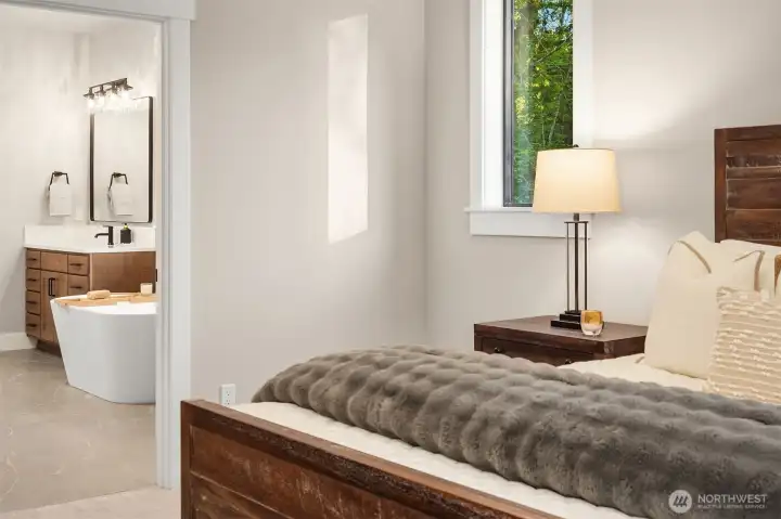 The luxurious main-level primary suite serves as a private retreat, complete with a spa-inspired bath and generous walk-in closet.