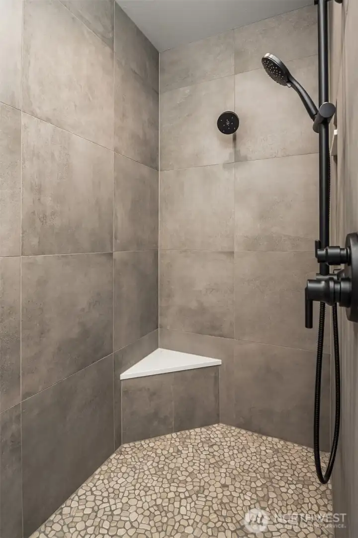 Spacious walk-in shower with a sleek, modern design.