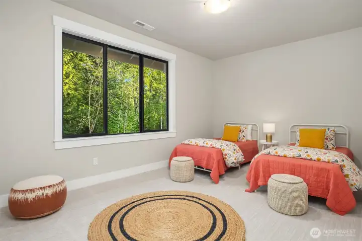Main-level secondary bedroom featuring front yard views.