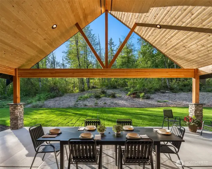 Outdoors, a stunning 20’ x 28’ covered living area overlooks the professionally landscaped grounds with Rain Bird irrigation, creating the perfect setting for year-round enjoyment.