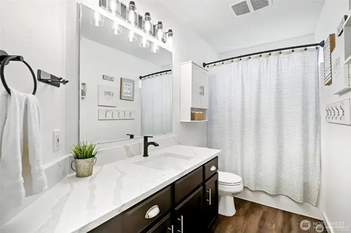 Upstairs bathroom with new LVP flooring & quartz countertop Upstairs bathroom with new LVP flooring & quartz countertop