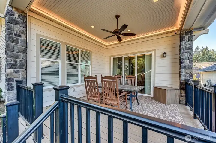 Covered deck with canned lights, perimeter ceiling lighting, a ceiling fan and a side sunscreen.