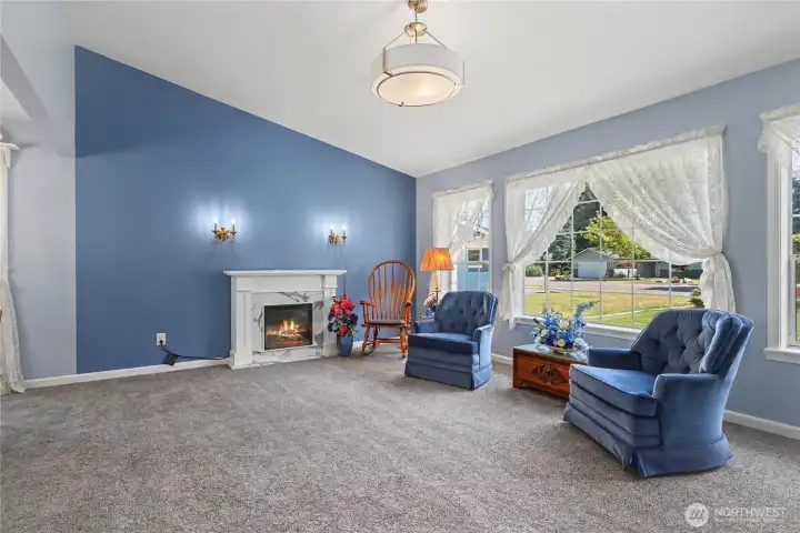 As you enter the home, to your right you will find your formal living room with cathedral ceilings & huge windows. Many new light fixtures throughout the home.
