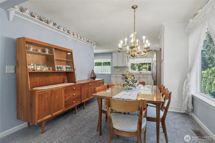 View of your formal dining room from the formal living room leading to the kitchen, large windows continue!